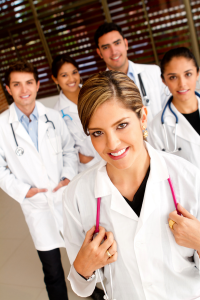 a group of doctors with a female doctor in front