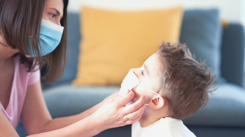 mother putting a mask on her child