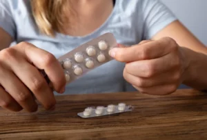 Woman's Hand Taking Medicine