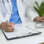 Healthcare professional writing an urgent care doctor's note