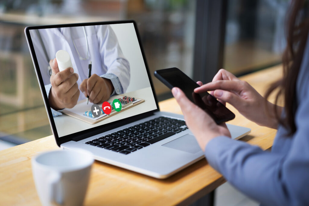 Person using laptop to get online consultation for medication refills
