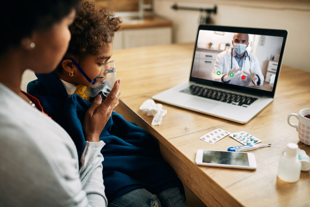 black-pediatrician-talking-via-video-call-mother-who-is-giving-her-daughter-inhaling-therapy-home