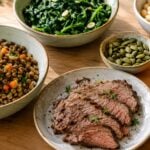 Table with iron-rich foods for anemia, including lentils, spinach, beef, beans, pumpkin seeds and orange slices