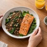 Bowl of lentils, spinach and salmon with orange juice and pumpkin seeds, iron-rich foods that help increase hemoglobin